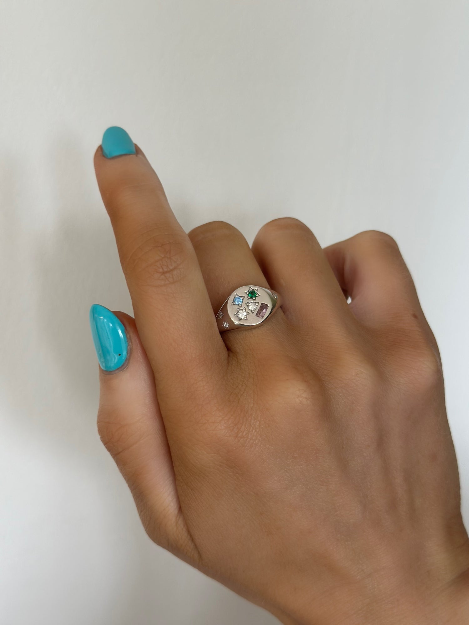 925 sterling silver adjustable ring with multi coloured cubic zirconia, blue, green clear and pink cubic zirconia