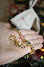 gold plated chunky earrings with star engraving and cubic zirconia stones, also features a chunky bracelet with green and pink square cubic zirconias 