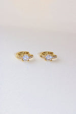 real 18k gold plated small Huggies with square central cubic zirconia at the centre of the earrings, and mini cubic zirconias surrounding it.